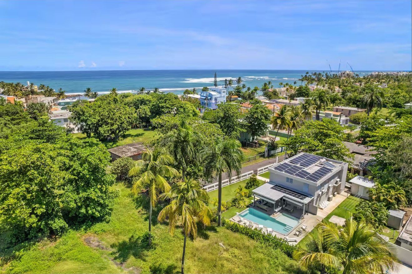 Aerial over the property toward the ocean horizon
